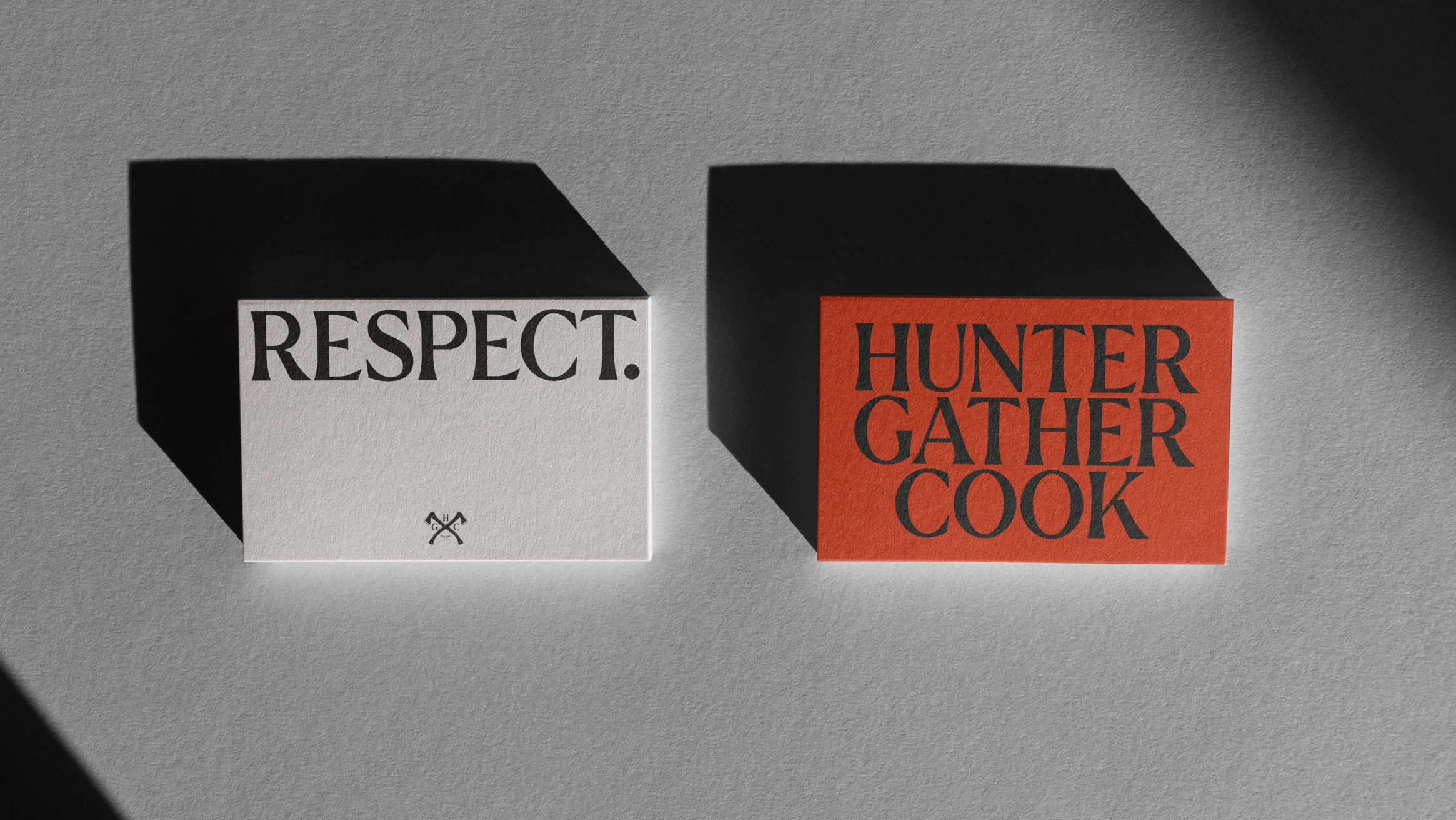 Business cards which have the primary Hunter Gather Cook logo on the front, and the word 'Respect' on the reverse