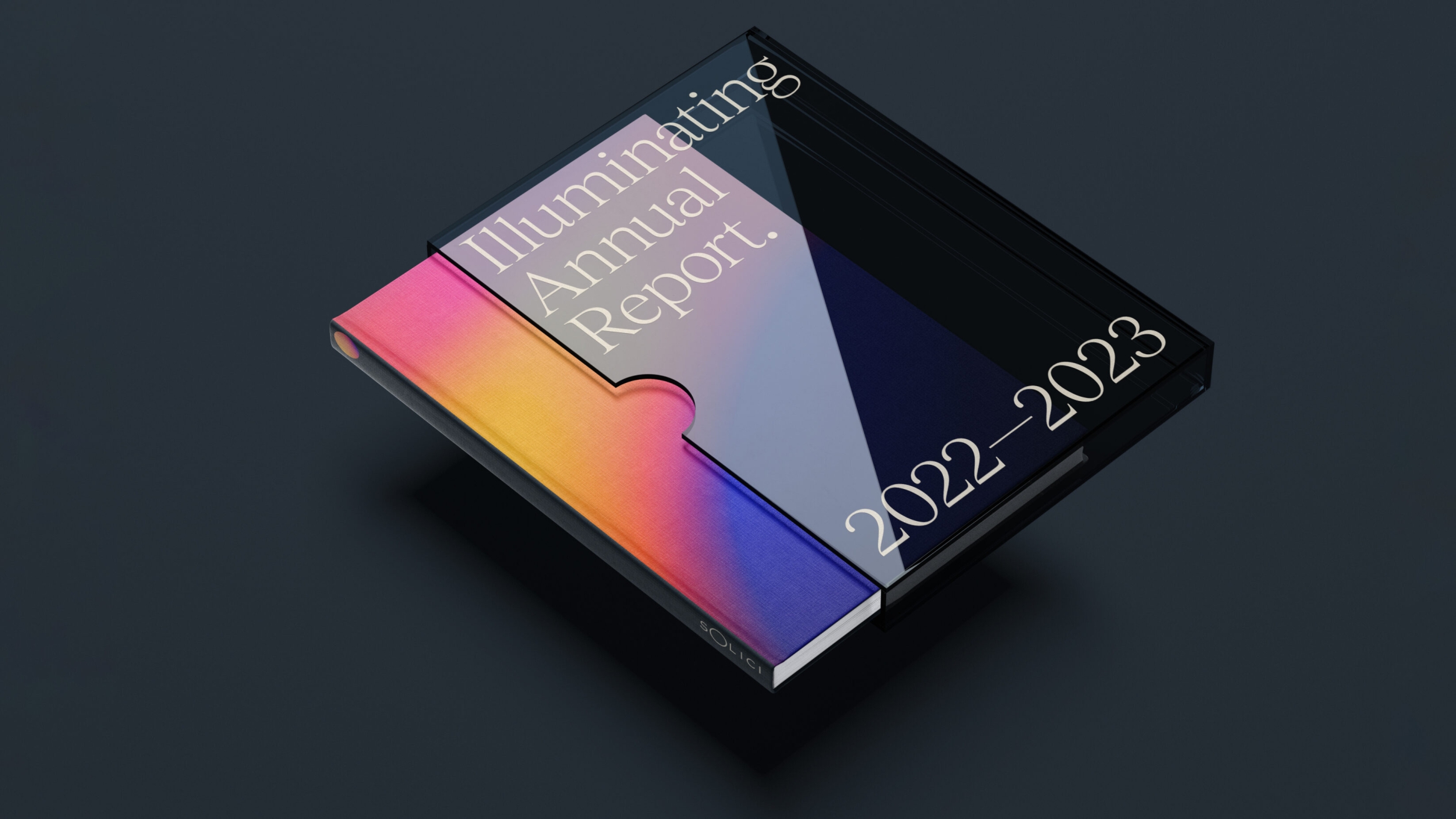 Illuminating Annual Report 2022-2023 is written on a tinted plastic book case with Solici's book peaking out in bold gradiented colours of pink, yellow and purple.