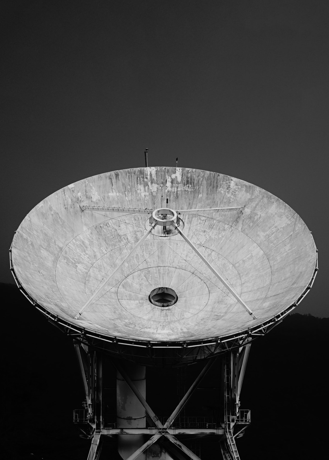 A black and white portrait close-up of a satellite dish