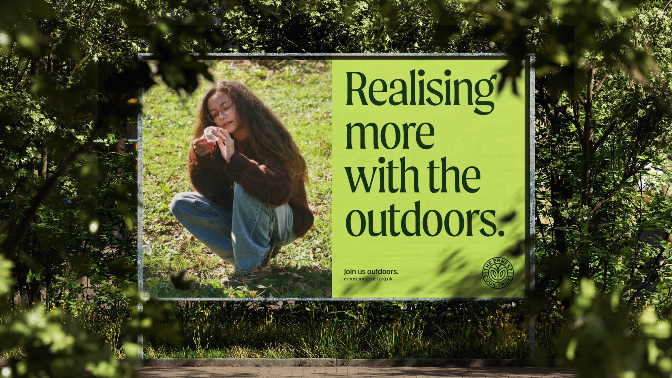 Billboard design with a girl looking at what she's found on the ground